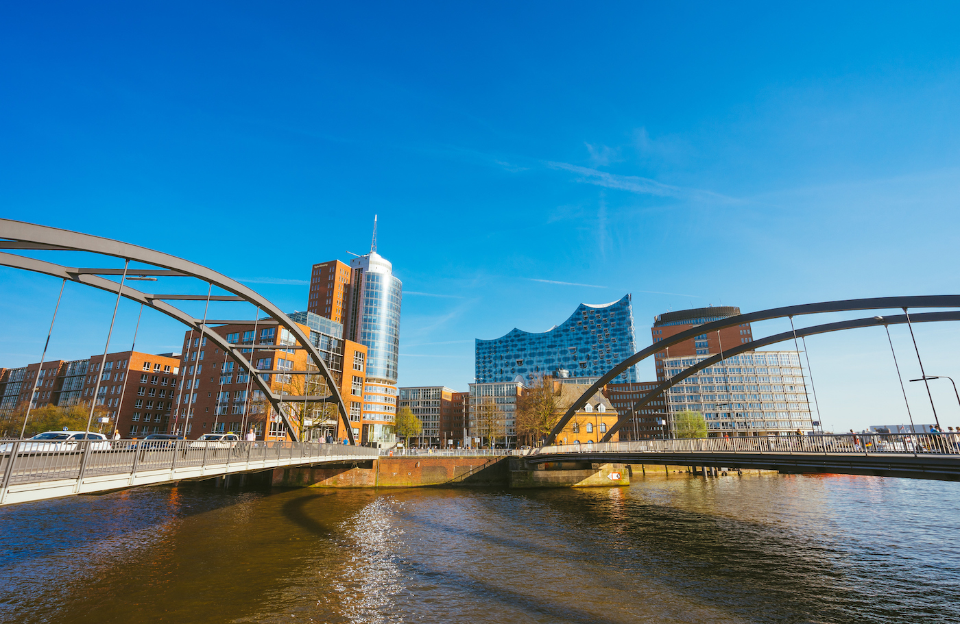 Food Ingredients Company, HafenCity, Speicherstadt: Panoramic view in front of the modern Elbphilharmonie building with Niederbaumbrucke Bridges in foreground